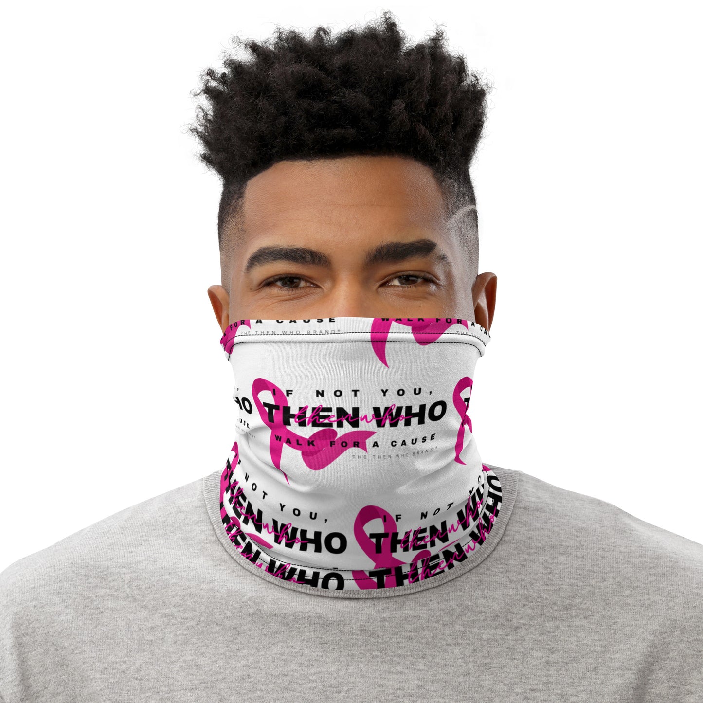 Person wearing a white face mask with pink ribbons and text on a white background