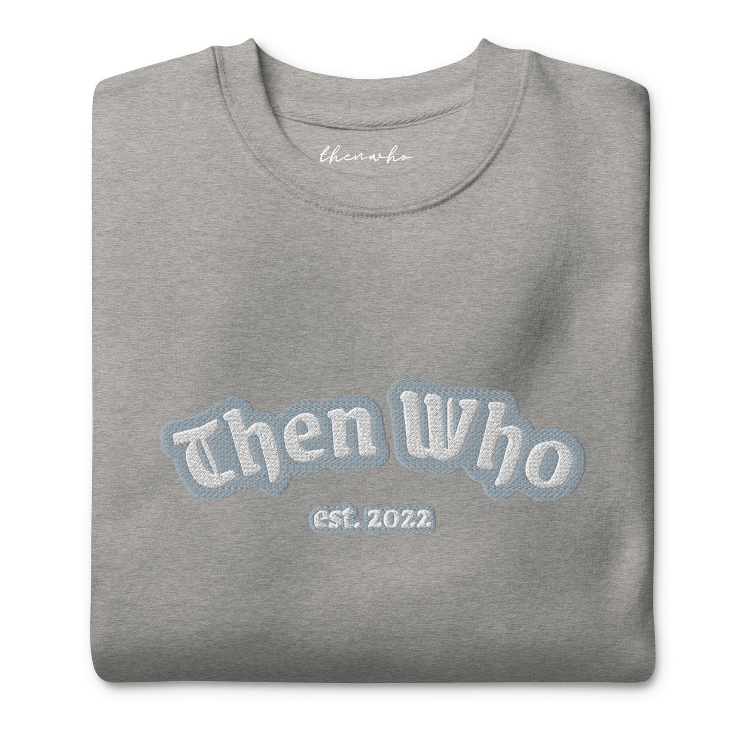 Folded gray sweatshirt with 'Then Who est. 2022' text on a white background