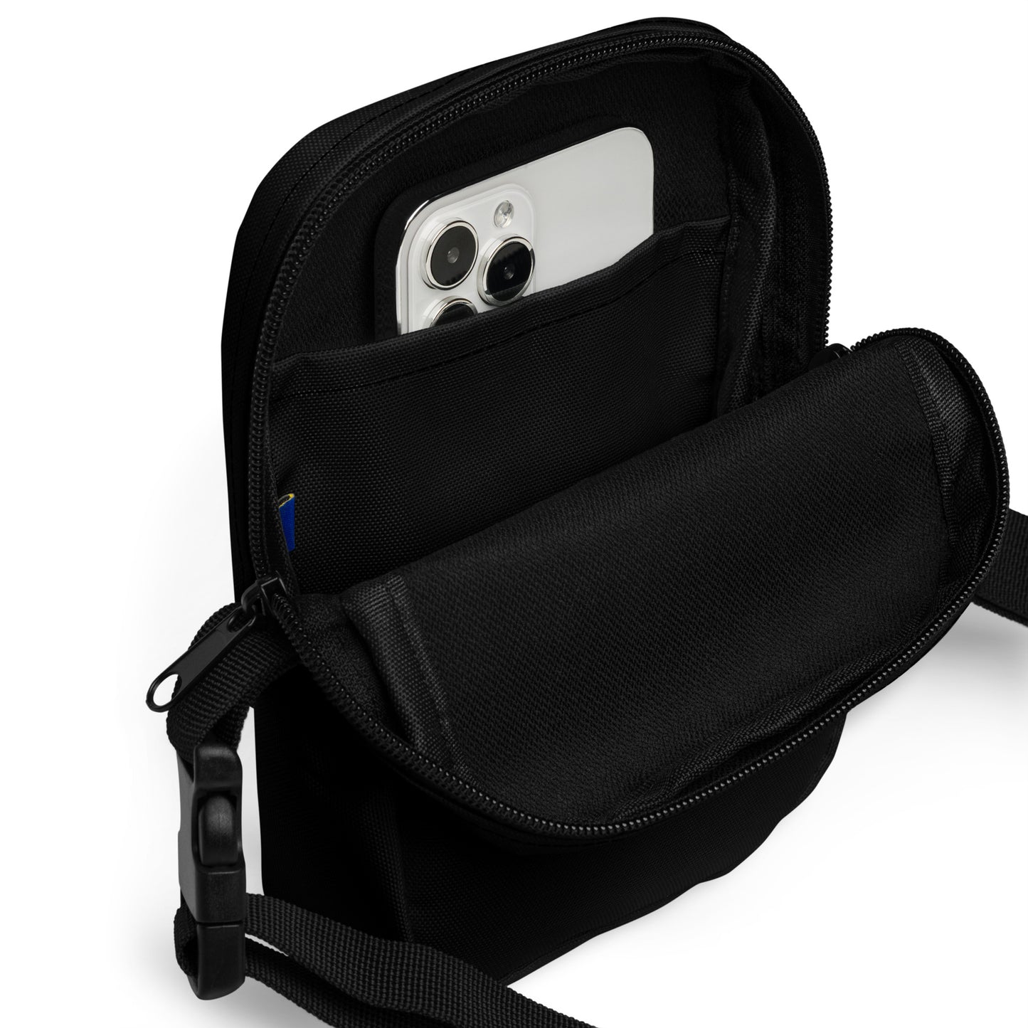 Black crossbody bag with a phone inside on a white background