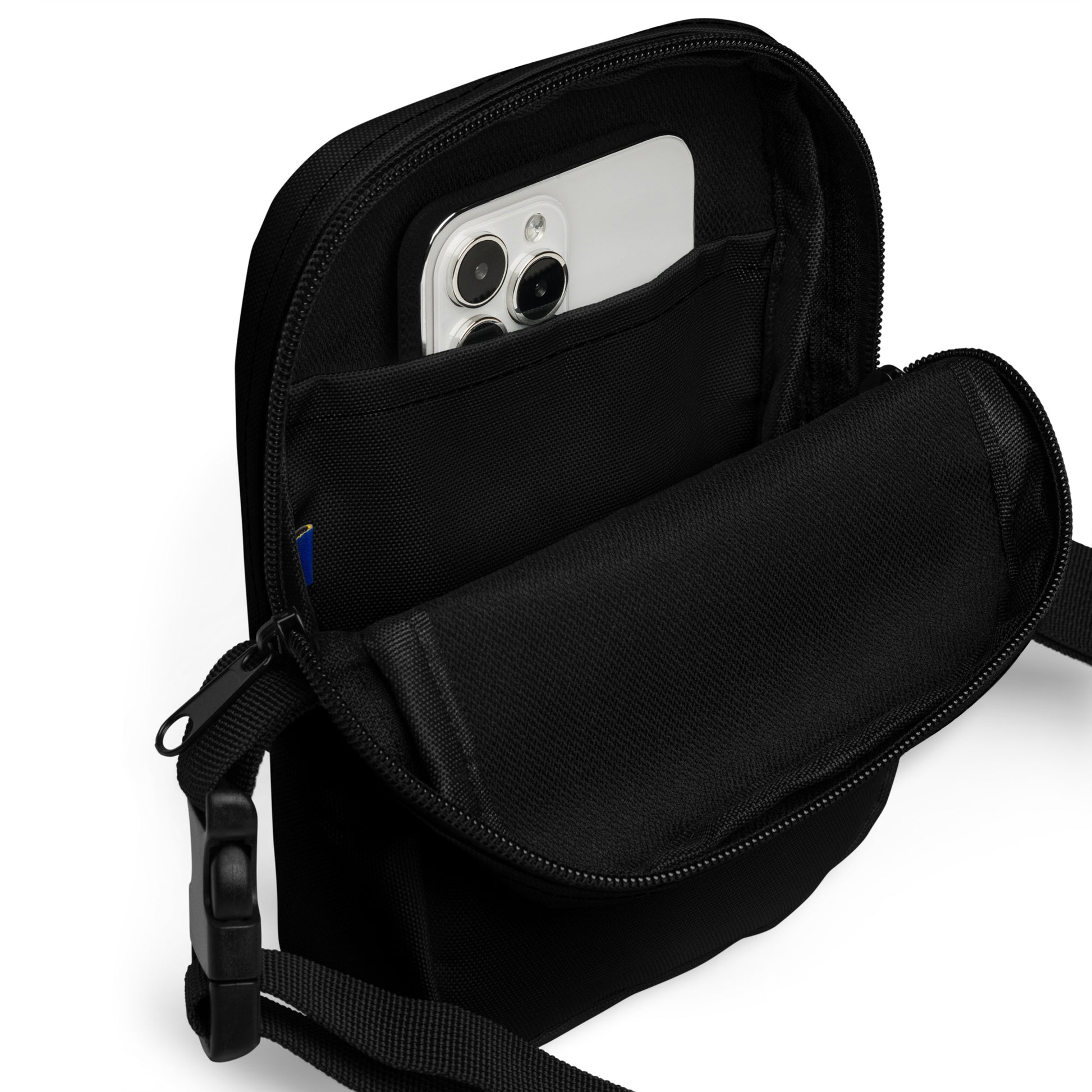 Black crossbody bag with a phone inside on a white background