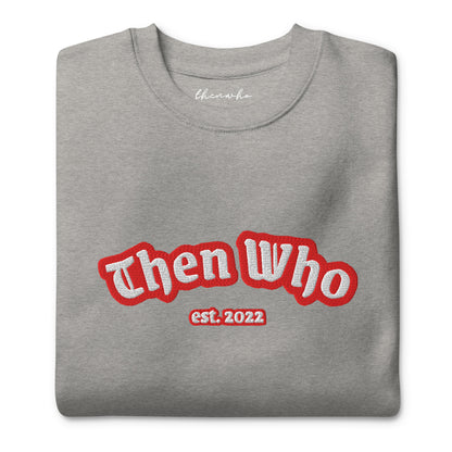 Folded gray sweatshirt with 'Then Who est. 2022' text in red and white on a white background