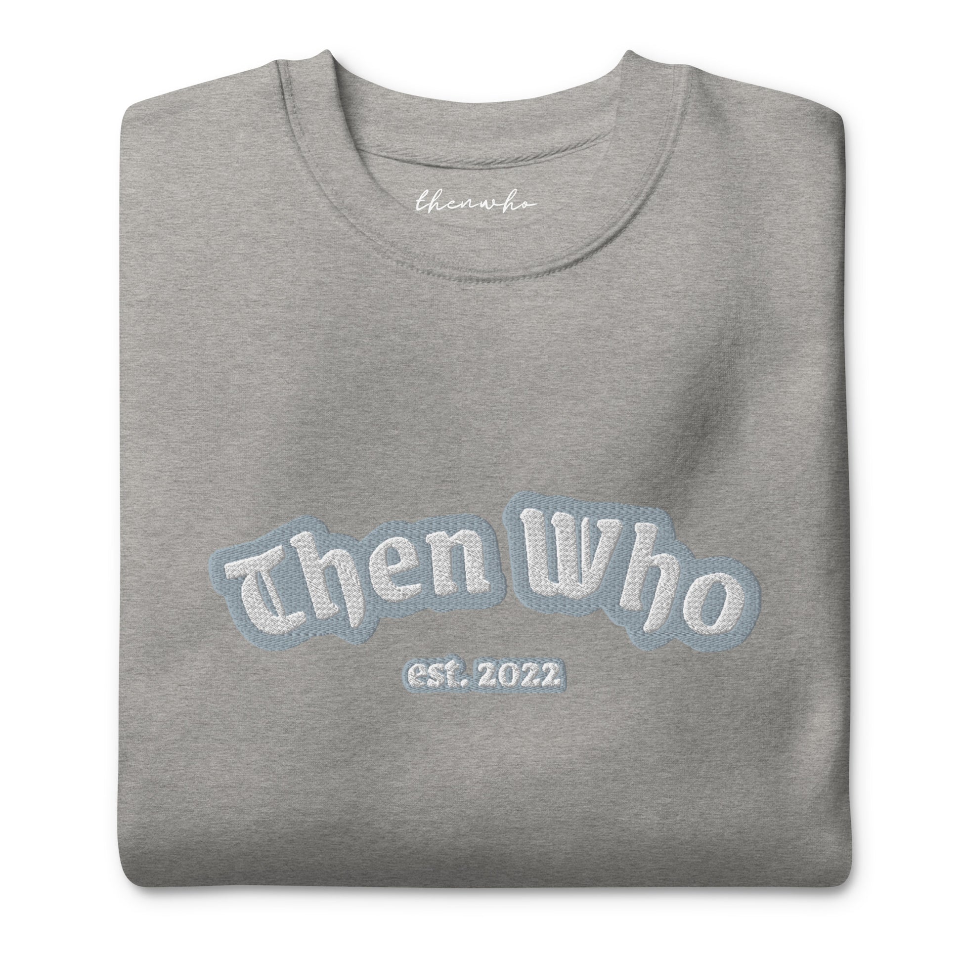 Folded gray sweatshirt with 'Then Who est. 2022' text on a white background