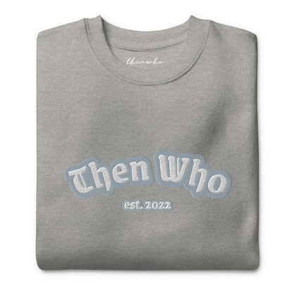 Folded gray sweatshirt with 'Then Who est. 2022' text on a white background